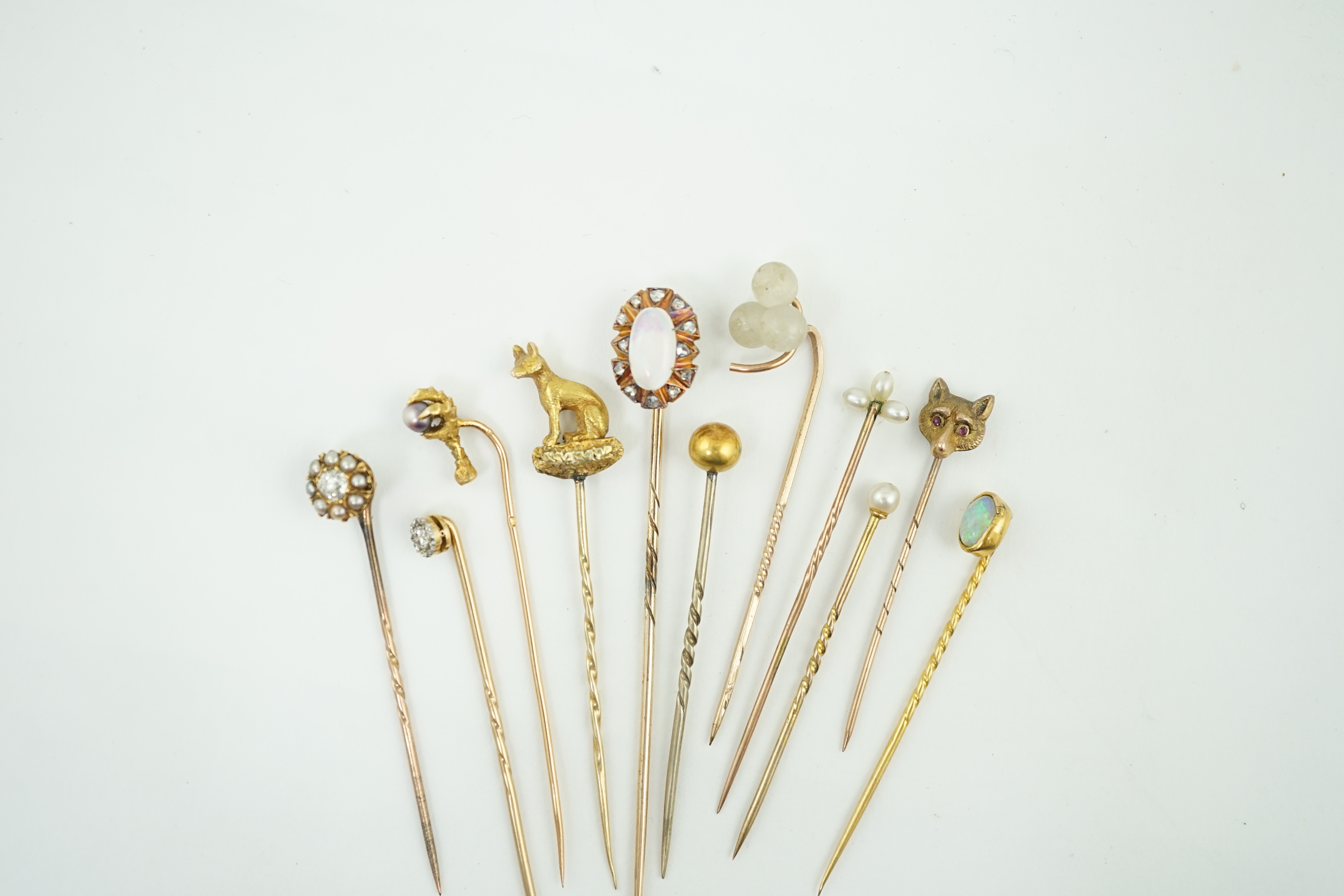 A collection of eleven assorted early 20th century and later stick pins